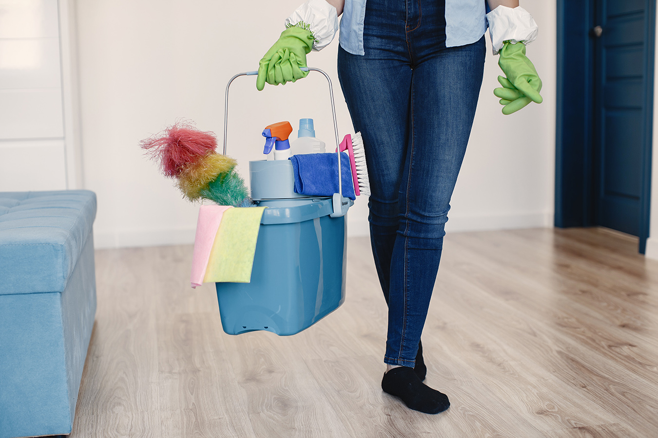 Woman with sponge and rubber gloves cleaning house