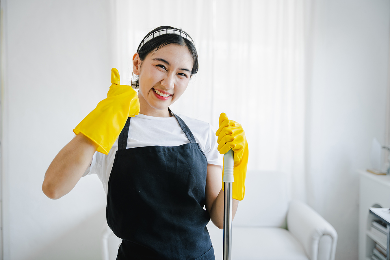 young woman mopping the floor cleaning at home smiling cheerful